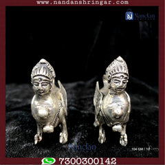 Fine silver pair of Kaamdhenu cows by Utsav Arts, showcasing intricate detailing and elegant craftsmanship.