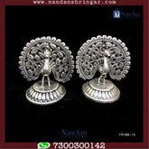 Utsav Arts Peacock Fine Silver earrings showcasing intricate design and vibrant peacock motif on a neutral background.