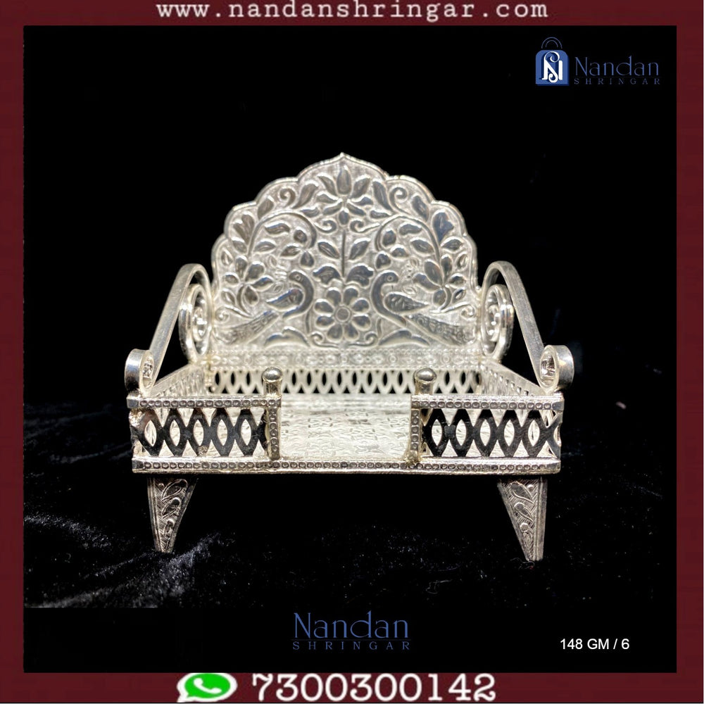 Fine silver Sinhasan by Utsav Arts, featuring intricate design and craftsmanship, showcased against a neutral background.