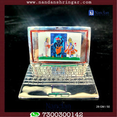 Fine silver laptop by Utsav Arts showcasing a sleek design and elegant finish.