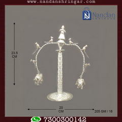 Fine silver ornament by Utsav Arts featuring intricate designs, showcasing craftsmanship and elegance in the image.