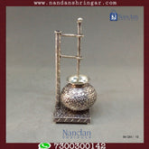 Fine silver carving Bilona set by Utsav Arts featuring intricate designs and elegant craftsmanship displayed on a soft background.