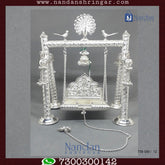 Premium fine silver carving palna by Utsav Arts, showcasing intricate designs and craftsmanship in a beautiful display.