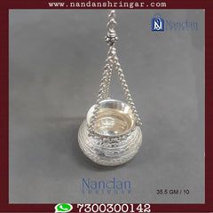 Fine silver hanging handi by Utsav Arts, featuring intricate designs and a polished finish, displayed against a neutral background.