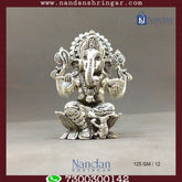 Fine silver Shree Ganesh idol by Utsav Arts, showcasing intricate detailing and traditional design elements.