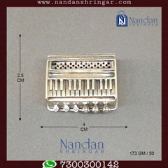 Fine silver musical set by Utsav Arts featuring intricately designed instruments and vibrant embellishments.