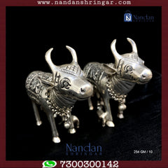 Fine silver cow figurines from Utsav Arts, featuring intricate detailing and a polished finish.