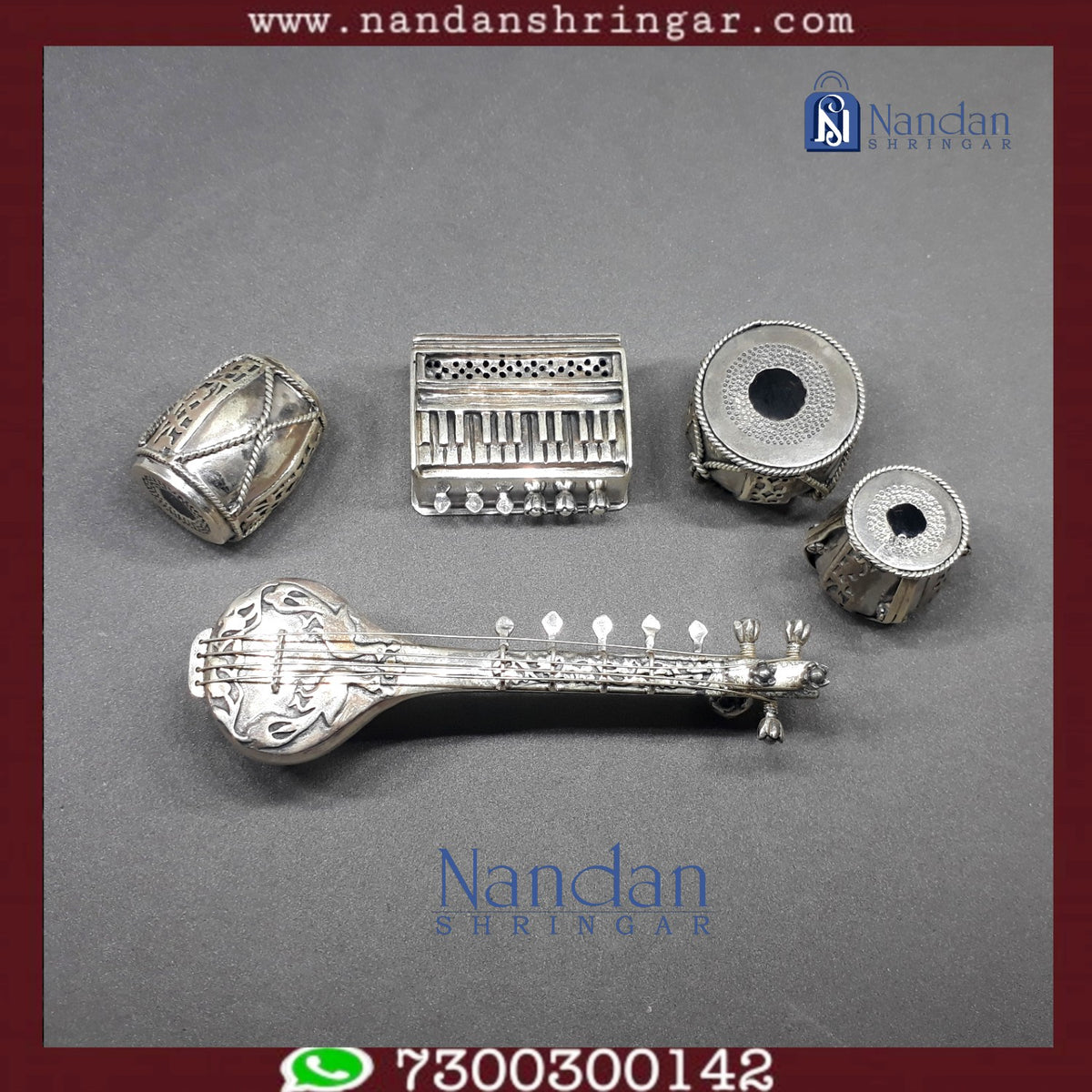 Fine silver musical set by Utsav Arts featuring intricate designs and instruments, displayed on a wooden surface.