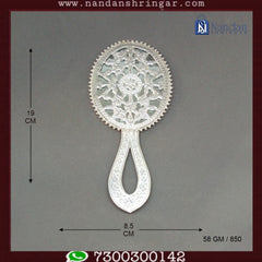 Fine silver Aarsi mirror by Utsav Arts, featuring intricate detailing and a reflective surface, displayed on a decorative stand.