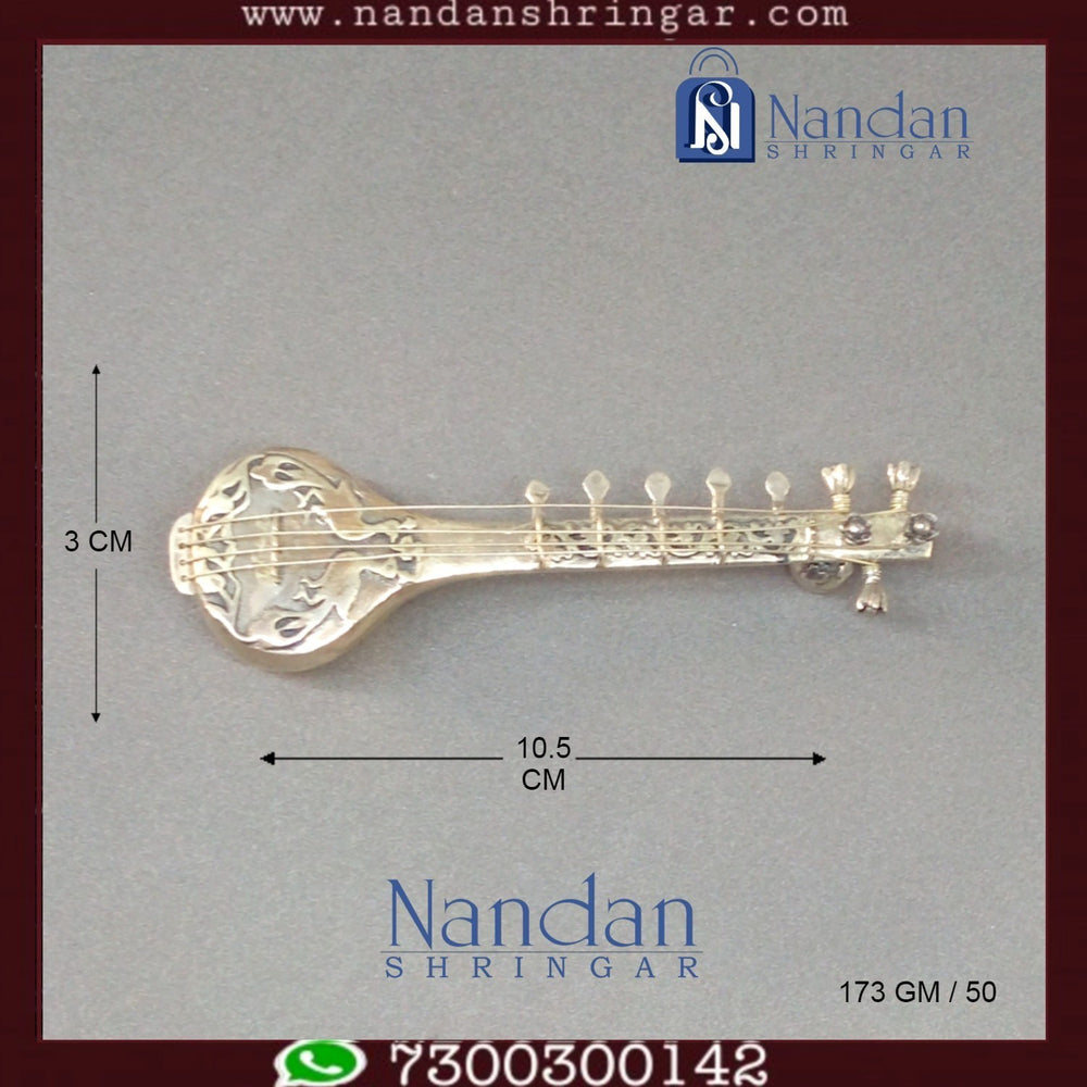Fine silver musical set by Utsav Arts featuring intricate designs and traditional craftsmanship displayed on a neutral background.
