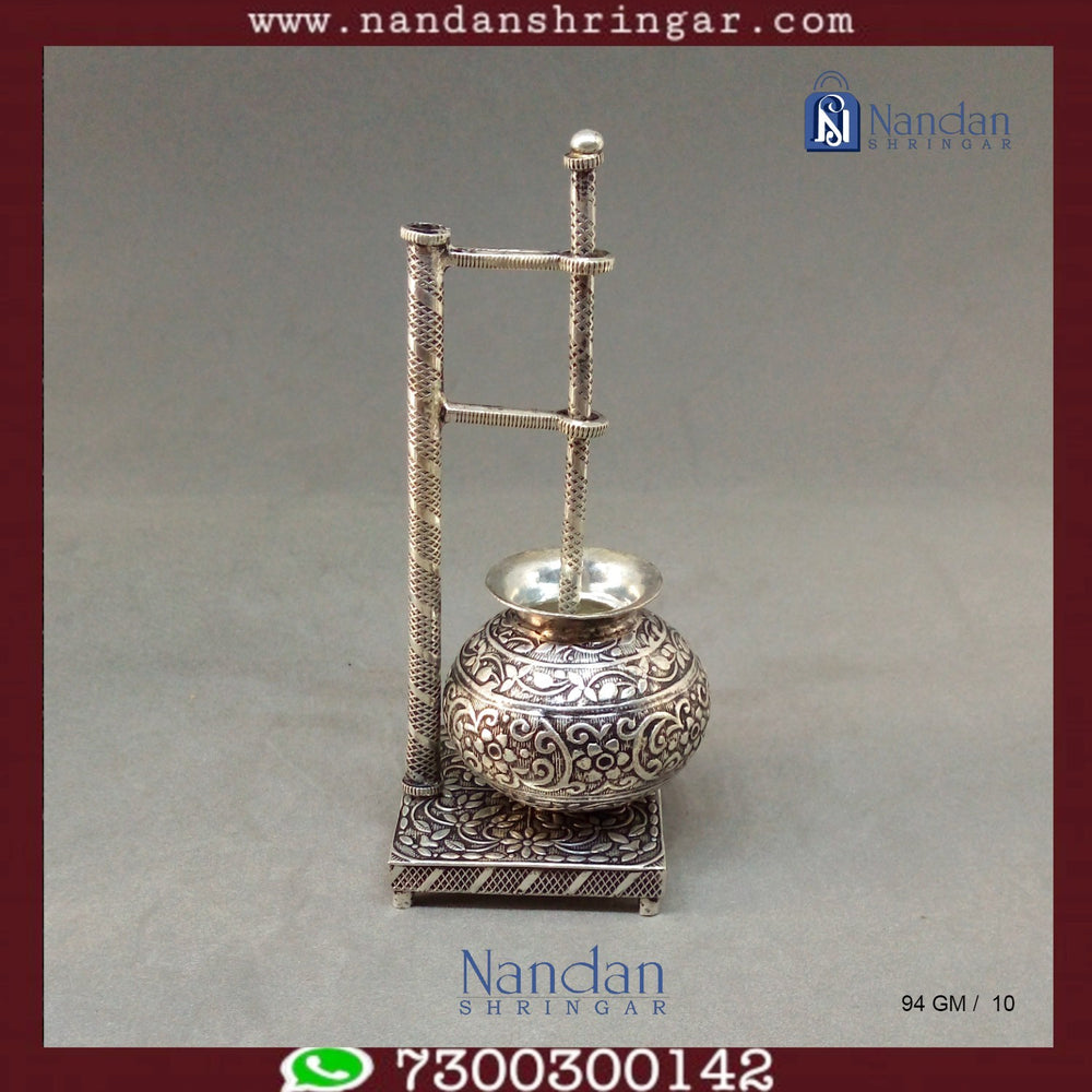 Fine silver carving Bilona set by Utsav Arts featuring intricate designs and elegant craftsmanship displayed on a soft background.
