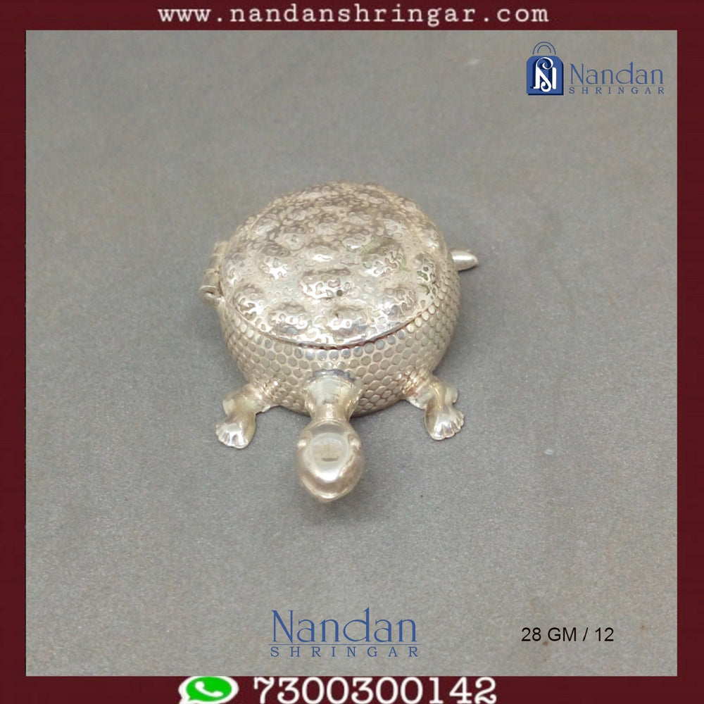 Fine silver tortoise sculpture by Utsav Arts, showcasing intricate details and craftsmanship in a decorative design.