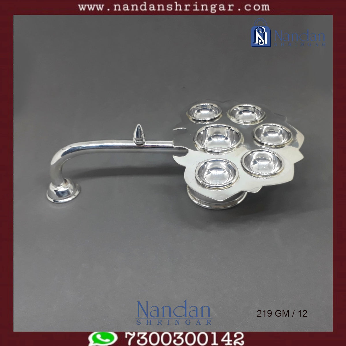 Fine silver Aarti by Utsav Arts, featuring intricate design and craftsmanship, displayed in elegant lighting.