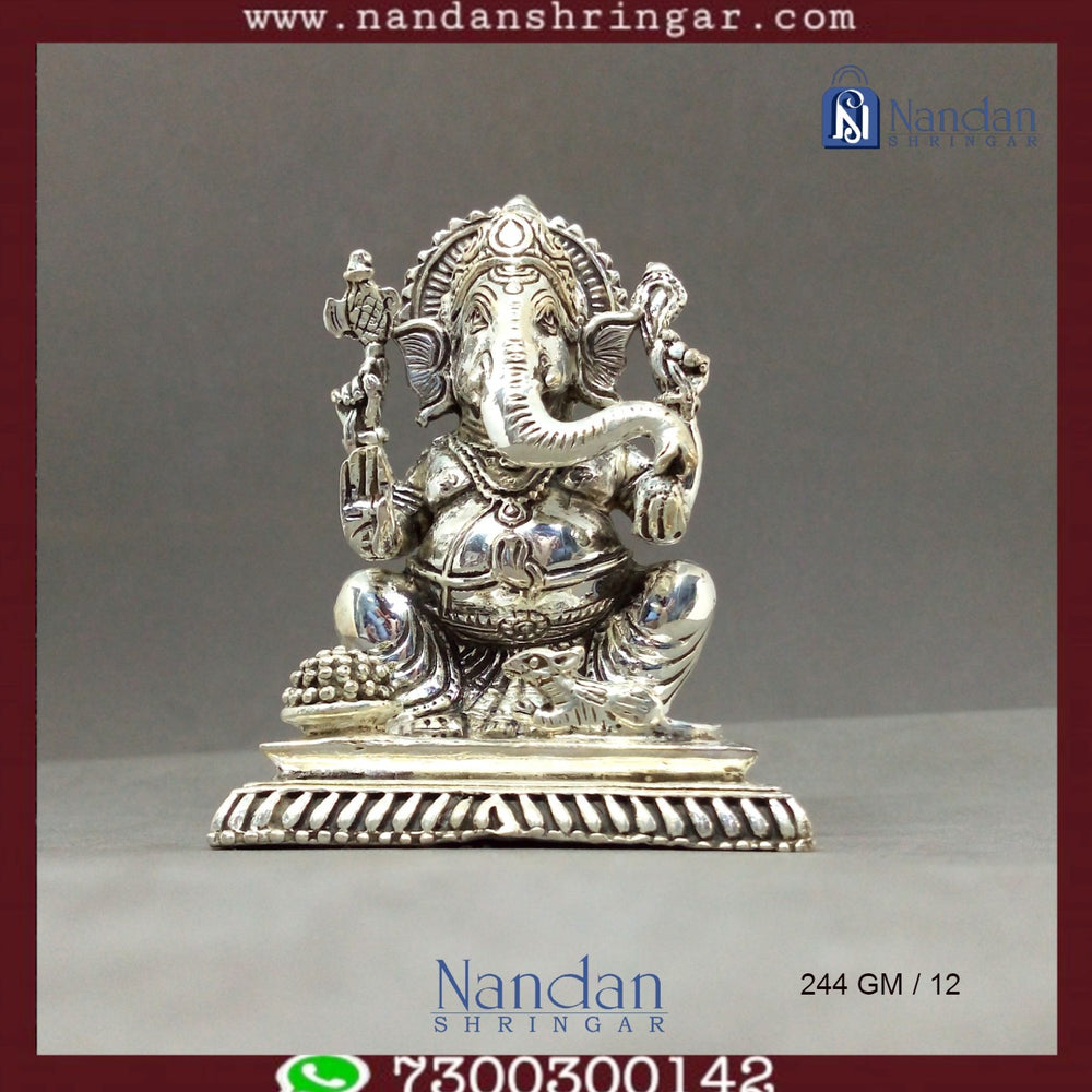 Fine silver Shree Ganesh idol by Utsav Arts, showcasing intricate detailing and craftsmanship in a traditional design.